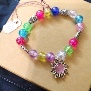 Artemis's Gems custom-made beaded bracelet with metal sun charm and owls rainbow